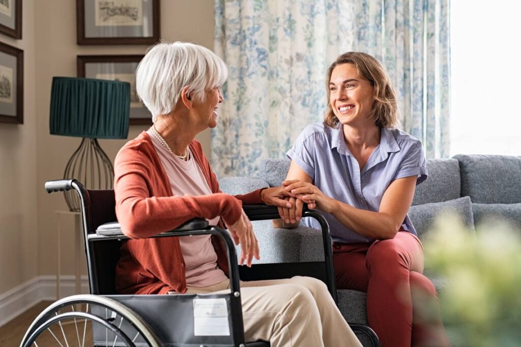 A woman sitting on the ground next to another person.